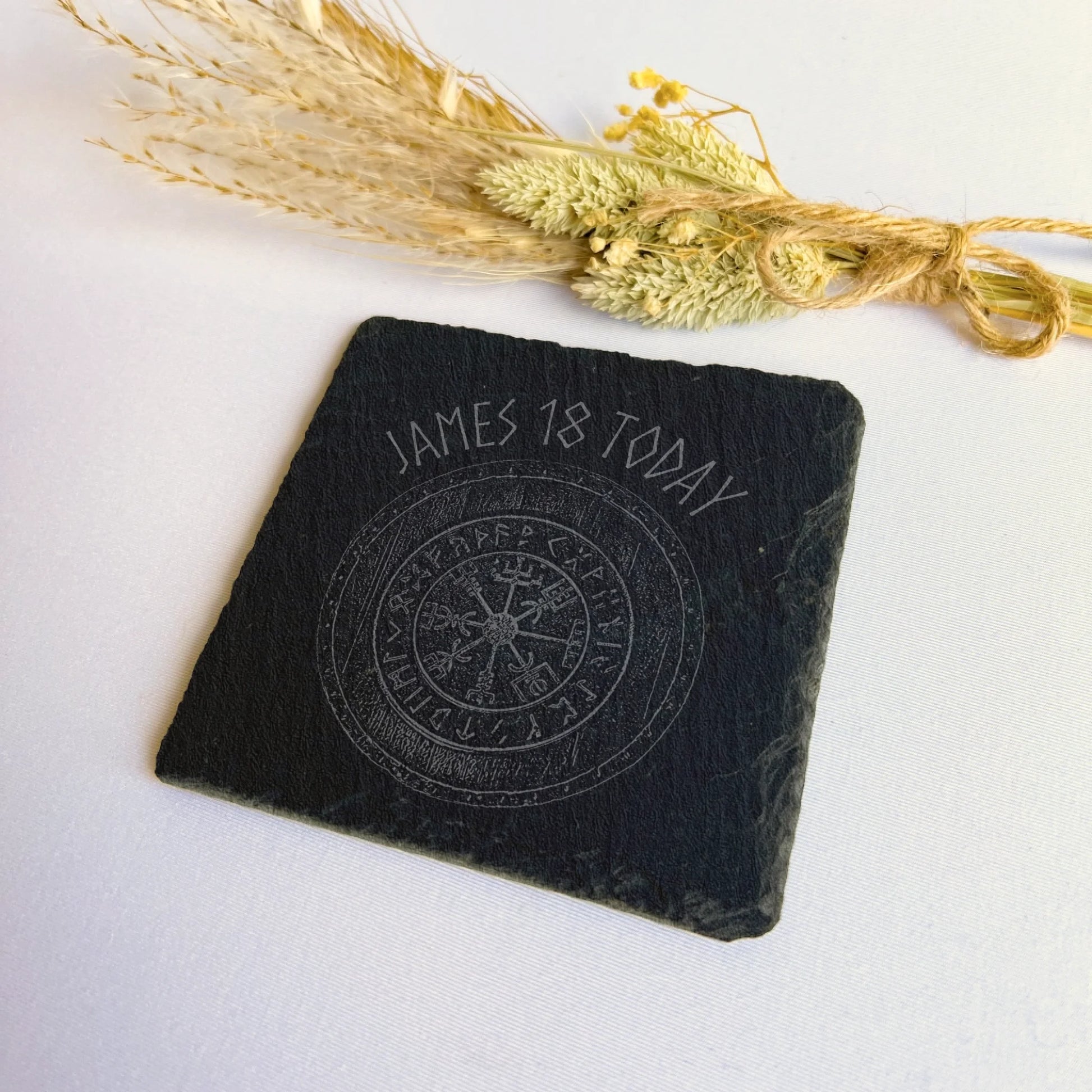 compass gift for him Square black slate coaster on a white surface with dried grasses, natural hand-cut edges, 10 cm square (4 in).