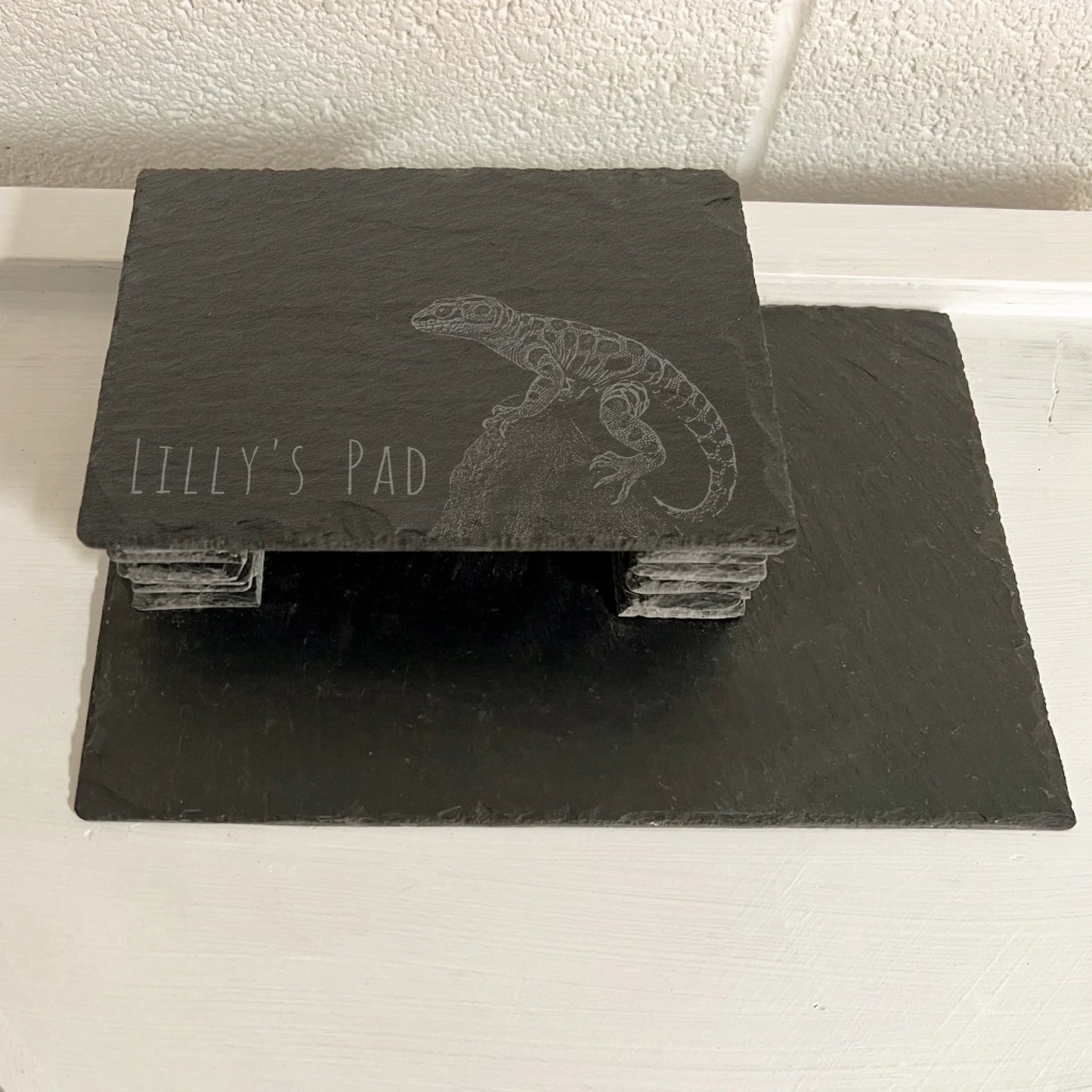 Leopard Gecko Slate reptile hide with rectangular roof and stacked slate side walls on a larger base on a white surface.